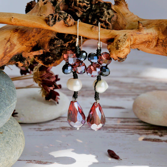 Beaded earrings with red and black crystal stones hanging on a branch and a natural pearl nestled in the black cord. 
Set on sterling silver hoops with a length of  4.3cm